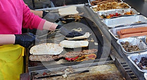 cook of the street food truck while preparing the sandwich