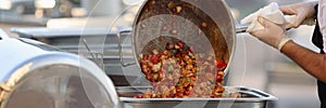 Cook wearing protective mendicine mask fry vegetables in pan photo