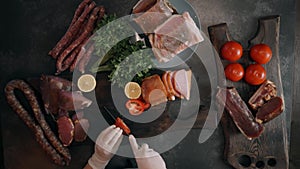 The cook in white clothes with a cap cuts tomato