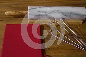 Cookbook on wooden table whit utensils