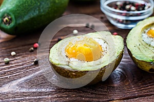 Cooked avocado with egg, pepper and salt