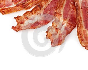 Cooked bacon rashers close-up isolated as a background. photo