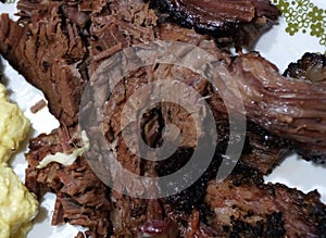 The cooked beef brisket on a white plate