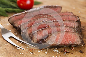 Cooked beef steak sliced medium rare close-up photo