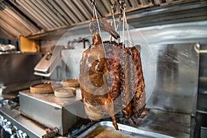 Cooked Beijing roast duck and smoked ribs on restaurant kitchen.