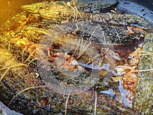 cooked bitter gourd in a pan with thread wrap or mash of bitter gourd closeup view