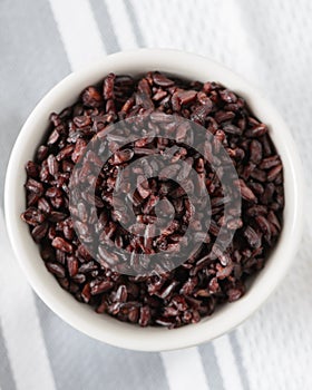 Cooked black rice in bowl