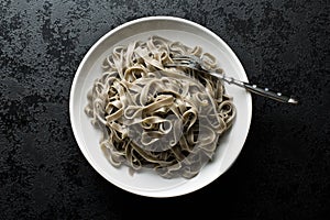 Cooked black tagliatelle pasta