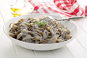 Cooked black tagliatelle pasta
