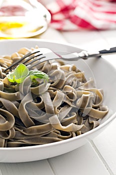 Cooked black tagliatelle pasta