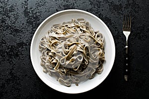Cooked black tagliatelle pasta