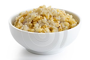 Cooked bulgur wheat in white ceramic bowl.