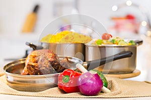 Cooked chicken with rice in white kitchen