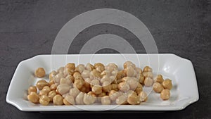 Cooked chickpeas Cicer arietinum in bowl on black background
