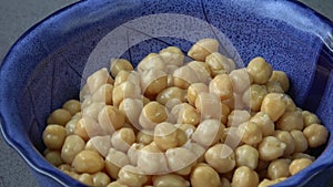 Cooked chickpeas Cicer arietinum in bowl on black background