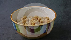 Cooked chickpeas Cicer arietinum in bowl on black background