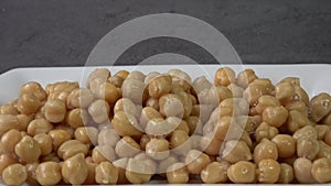 Cooked chickpeas Cicer arietinum in bowl on black background