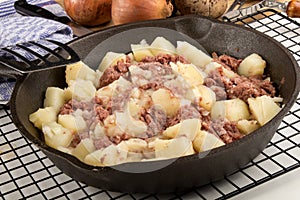 Cooked corned beef hash in a cast iron pan