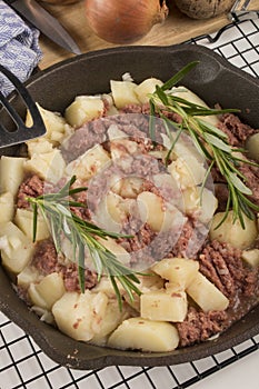 Cooked corned beef hash in a cast iron pan