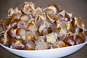 Cooked edible chestnuts on a plate.