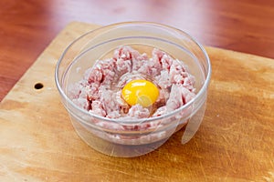 Cooked fresh mince for dish with raw egg lie in a plate