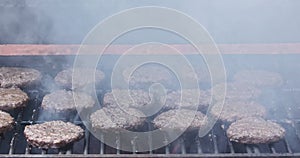 Cooked grilled beef meat barbecue burgers for hamburgers on the bbq fire flame grill as part of cooking process