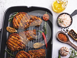 Cooked grilled meat pork, beef, chop on a bone, on grill pan, spices