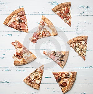 Cooked home meat pizza with rocket salad and cherry tomatoes, on a white rustic background, space for text