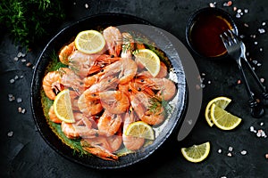 Cooked large shrimps with lemon, dill and tomato sauce. Healthy food. Top view.