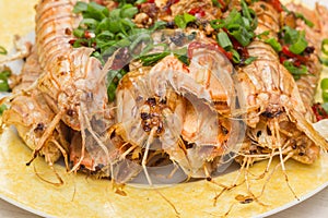 Cooked mantis Stomatopoda shrimp with spring onion and red pepper