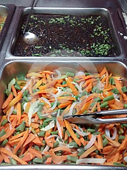 COOKED MIXED VEGETABLES AND BLACK CARAOTAS LISTS TO EAT IN RESTAURANT photo