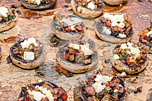 Cooked mushrooms stuffed with vegetables, cheese and meat