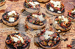 Cooked mushrooms stuffed with vegetables, cheese and meat