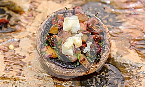 Cooked mushrooms stuffed with vegetables, cheese and meat