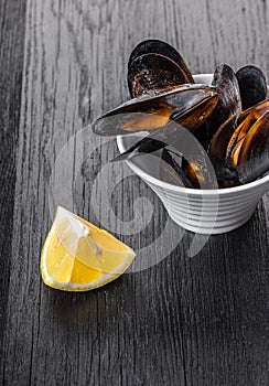 Cooked mussels in a bowl with lemon