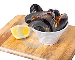 Cooked mussels in a bowl with lemon