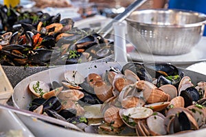 Cooked mussels and seafood in pan, food market Ballaro in Palermo