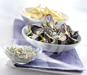 Cooked mussels served in a bowl with sauce