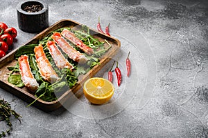 Cooked Organic Alaskan King Crab Legs with Butter, on gray stone table background, with copy space for text