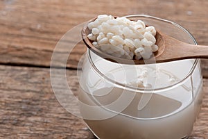 Cooked peeled barley grains in wooden bowl