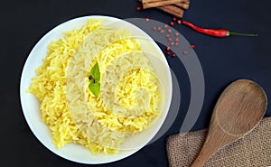 Cooked pilau rice in a white plate