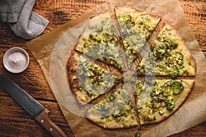 Cooked pizza with broccoli and cheese