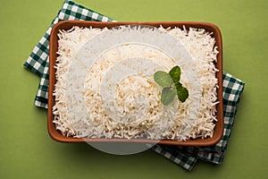 Cooked plain white basmati rice in terracotta bowl, selective focus photo