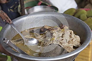 Cooked pork guts in a bowl at a street food stall in Cambodia