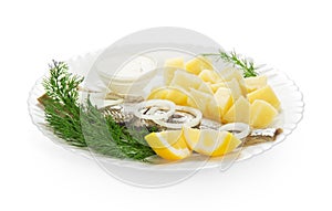 Cooked potatoes with herring and sauce