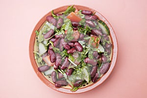 Cooked red beans plate on pink background, isolated. Healthy food