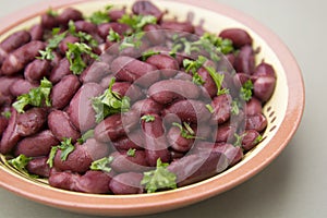 Cooked red beans plate on pink background, isolated. Healthy food