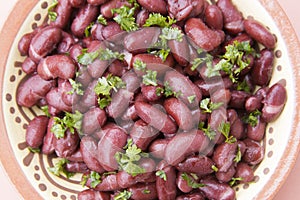 Cooked red beans plate on pink background, isolated. Healthy food