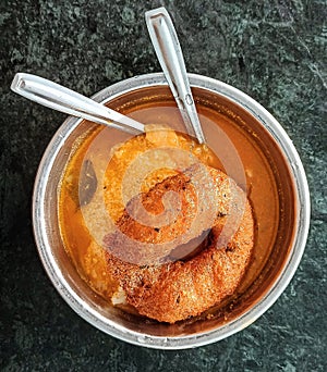 Cooked rice dipped in sambar along with Medu vada