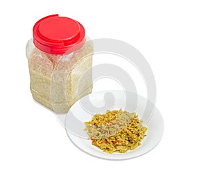 Cooked rice on dish and uncooked rice in plastic container